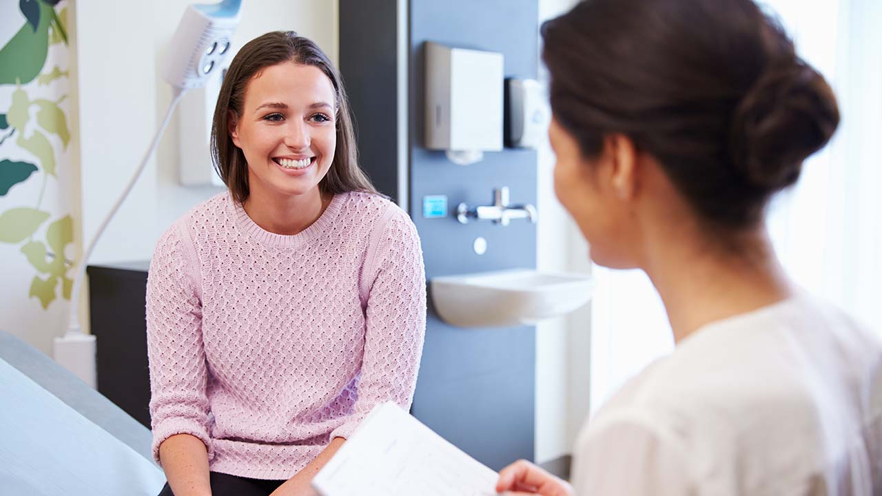 patient sitting on exam tabletalking to a doctor about the weight loss program