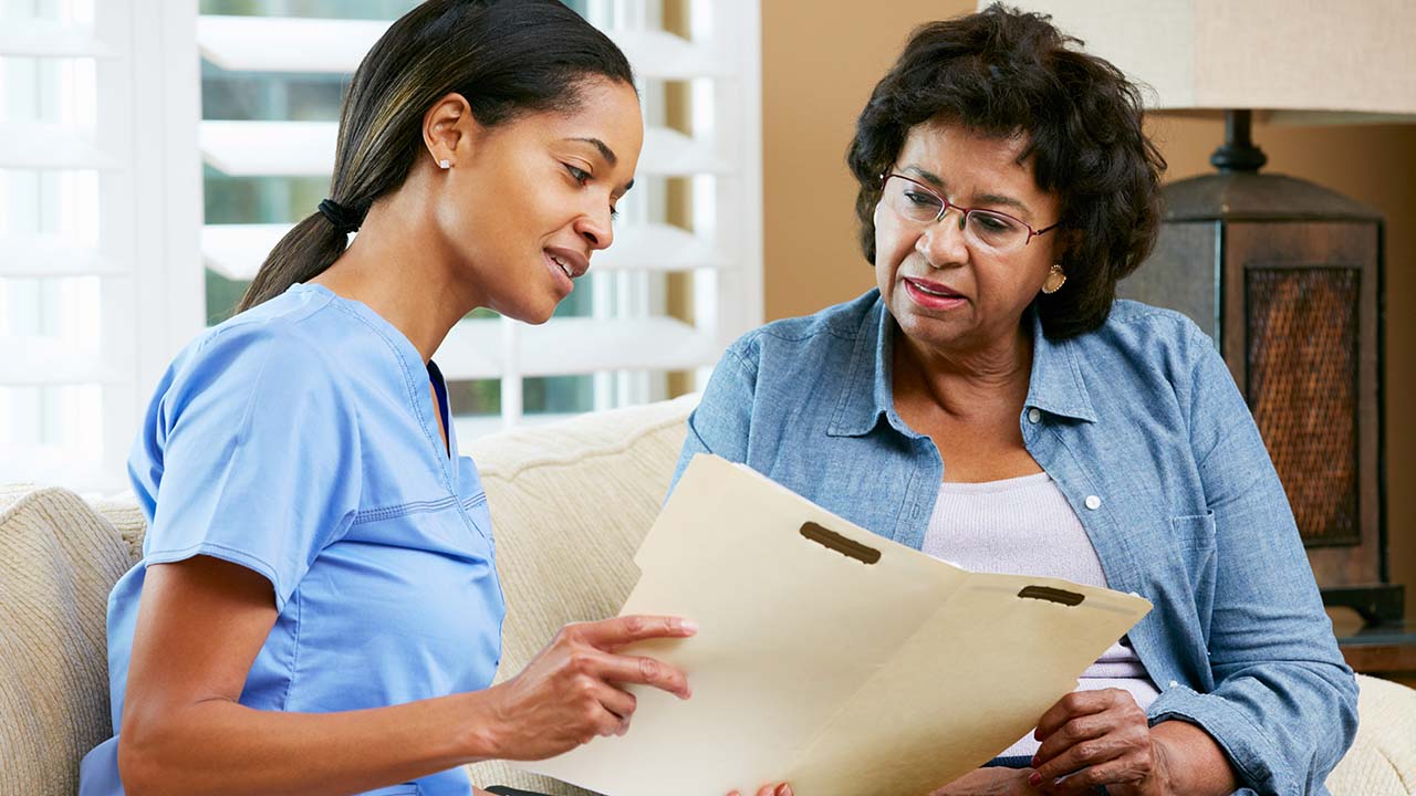 patient and nurse in scrubs discussing the weight loss plan